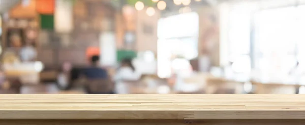 Wood table top on blur coffee shop (cafe) interior background Stock Photo  by ©kritchanut 155692472