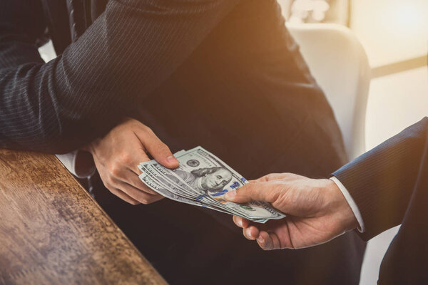 Businessmen secretly passing money