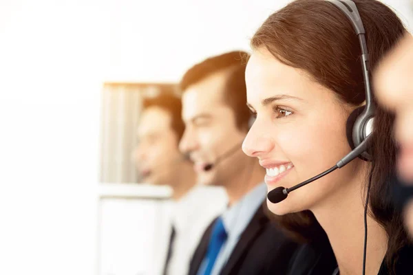 Smiling call center (or telemarketer) staff — Stock Photo, Image