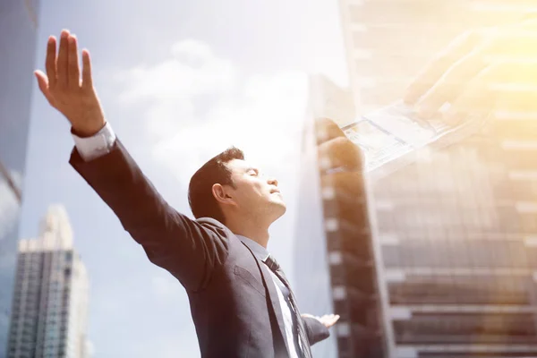 Sucess businessman in the city raising his arms, open palms, with face looking up — Stock Photo, Image