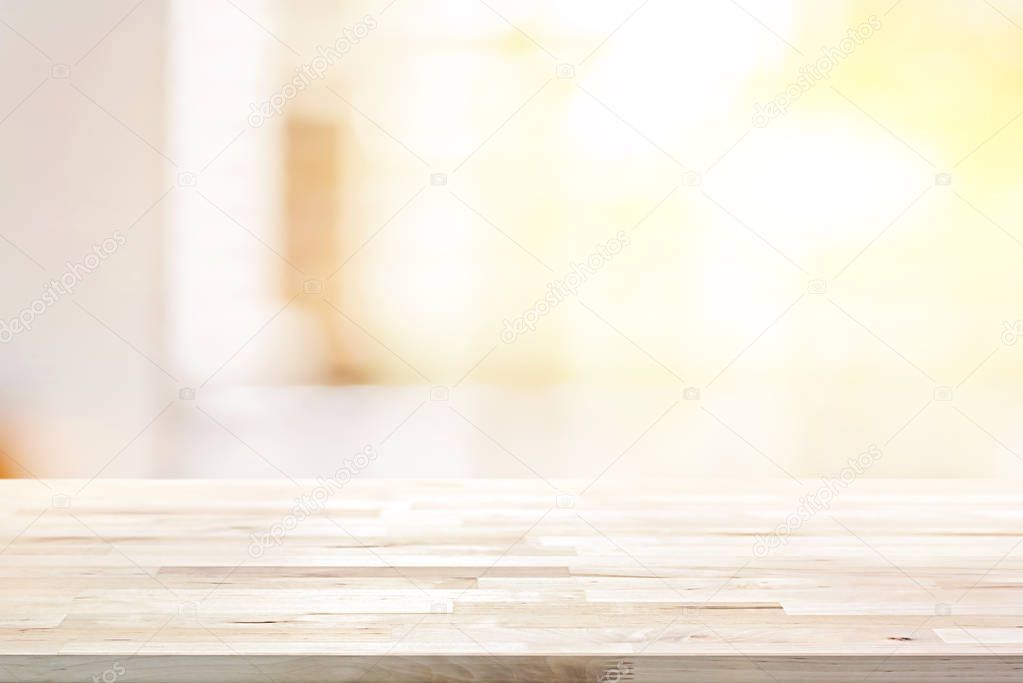Wood table top on blur abstract white background with shiny light
