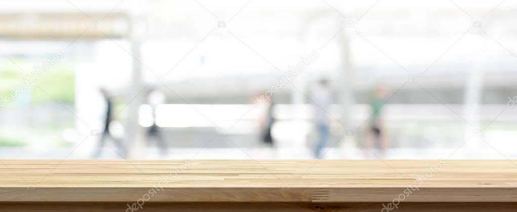 Wood table top on white blur abstract banner background from outdoor covered walkway 