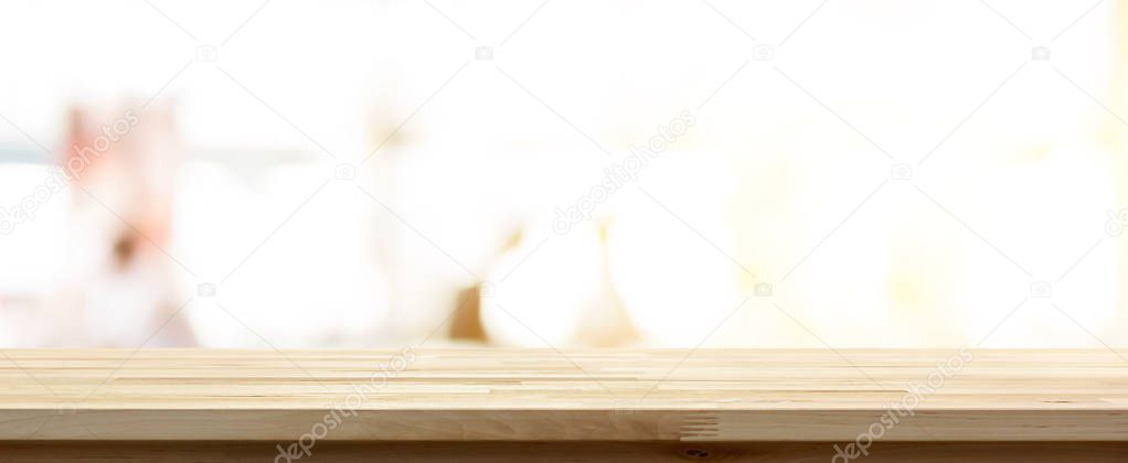 Wood table top on blur white room background with bright shining light, panoramic banner - can be used for display or montage your products 