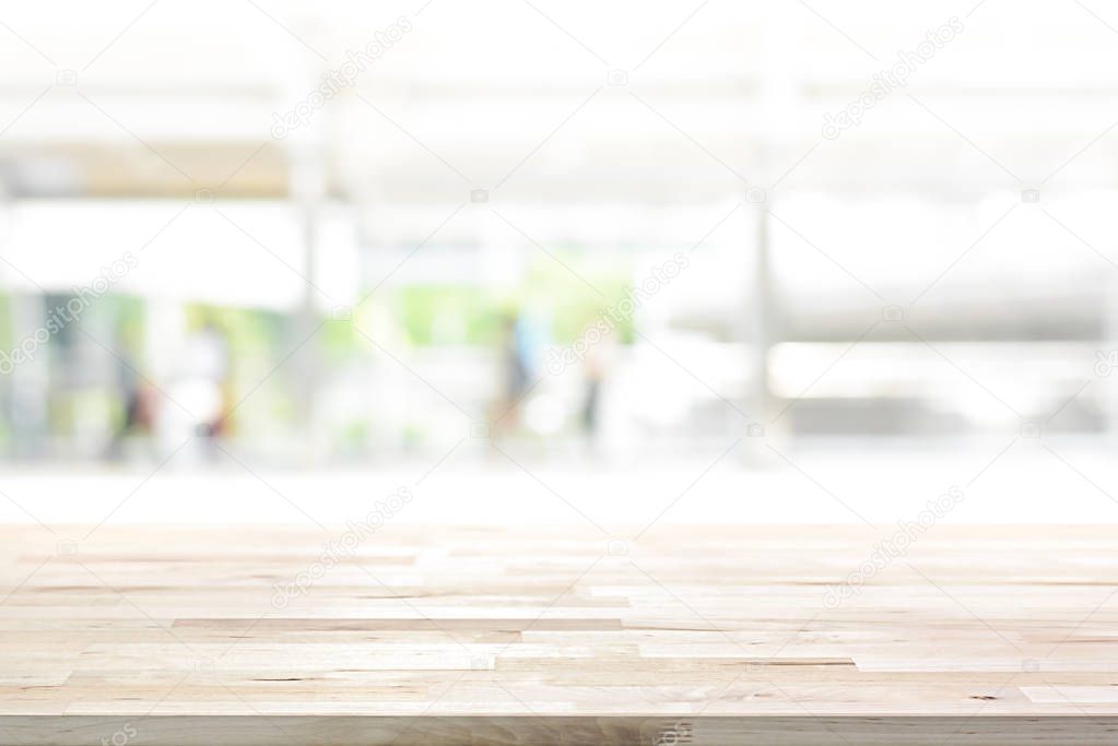 Wood table top on white blur abstract background from outdoor covered walkway in the city