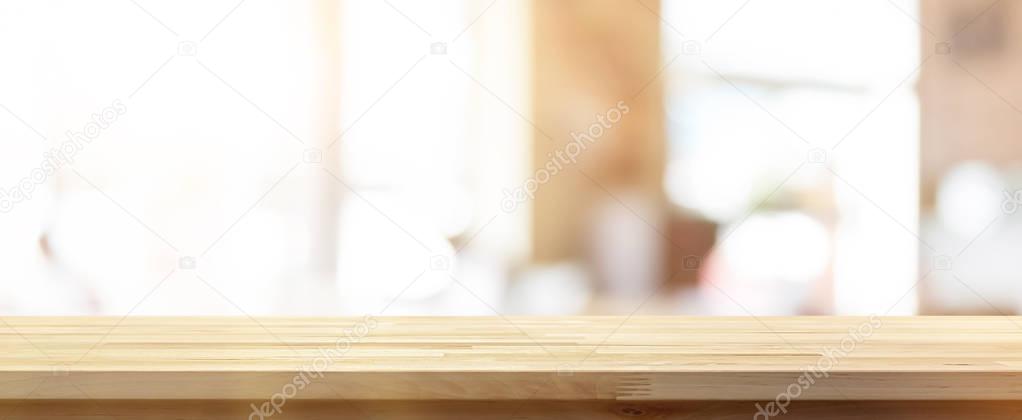 Wood table top on blur restaurant interior banner background