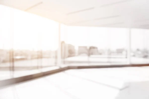 Blur empty office room with glass wall, city view