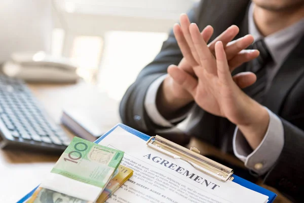 Businessman refusing money that come with agreement paper — Stock Photo, Image