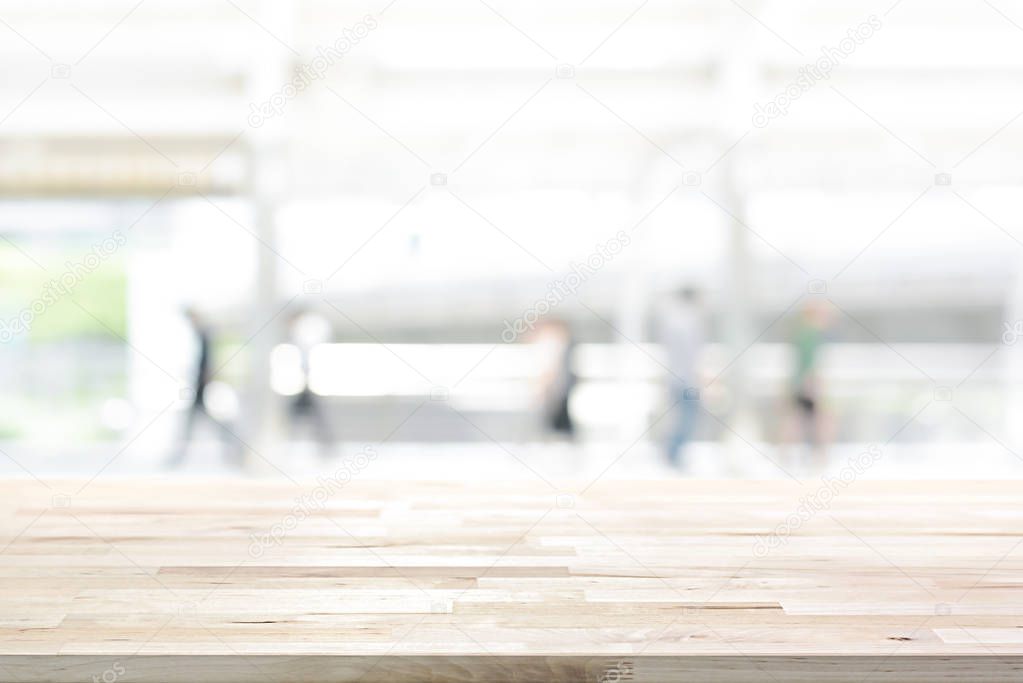 Wood table top on white blur abstract background from outdoorcovered walkway in the city