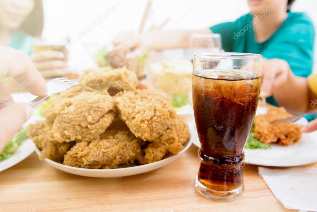 Fried chicken and soft drink on dining table