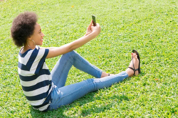 Młoda kobieta afro dorywczo, biorąc selfie — Zdjęcie stockowe