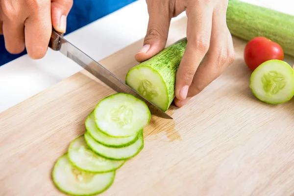 Cucumber being sliced  by a knife Royalty Free Stock Photos