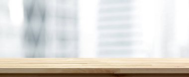 Wood table top on blur  city office building  background, panora clipart
