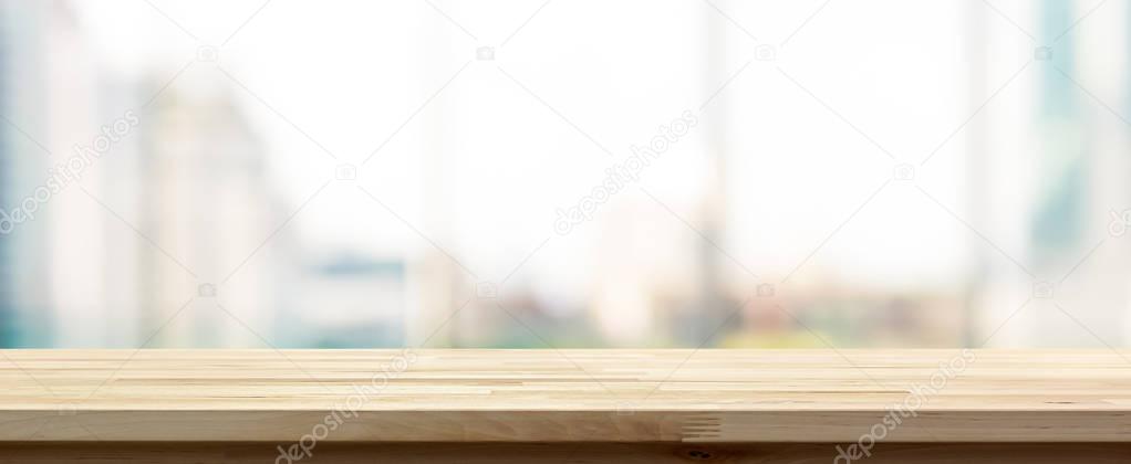 Wood table top on blur  city building view background looking th