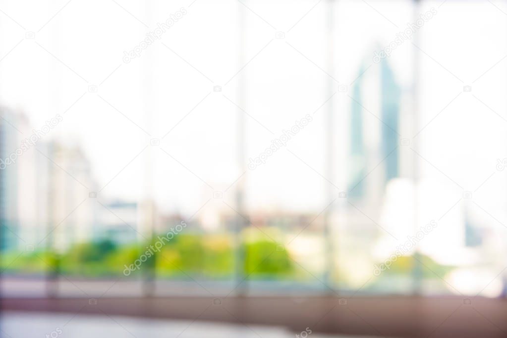 Blurred hallway inside office building with city view