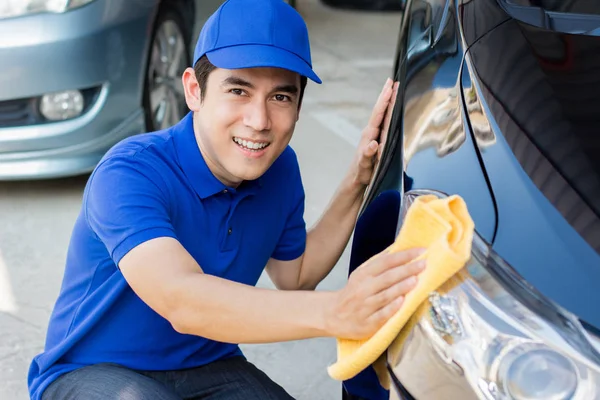 Jonge man auto polijsten (schoonmaak) met microvezel doek — Stockfoto