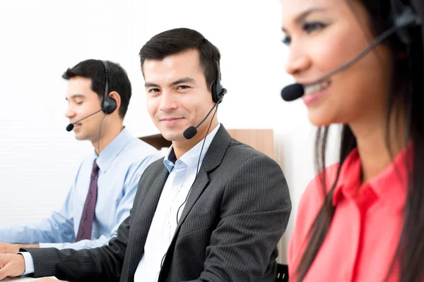 Call center workers wearing microphone headsets — Stock Photo, Image