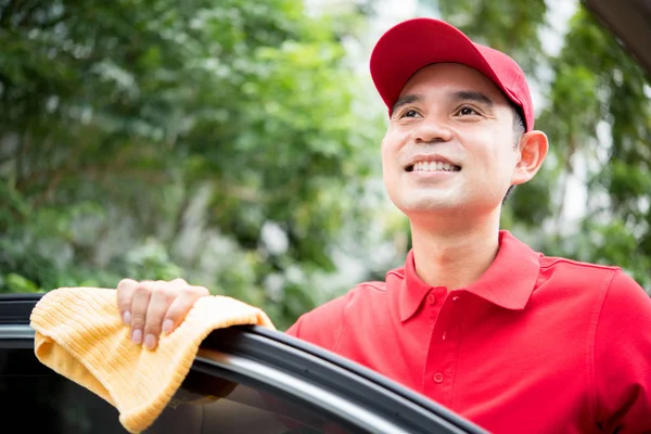 Sourire du personnel du service automobile (rêverie) tout en nettoyant — Photo