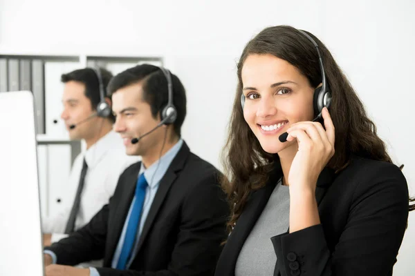 Smiling business woman working in call center — Stock Photo, Image