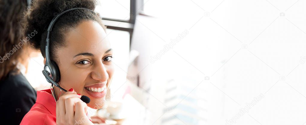 Smiling black businesswoman working in call center 