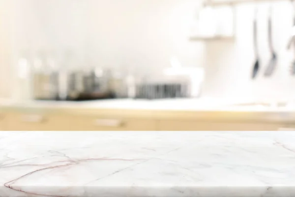 Marble stone table top (kitchen island) on blur kitchen interior — Stock Photo, Image