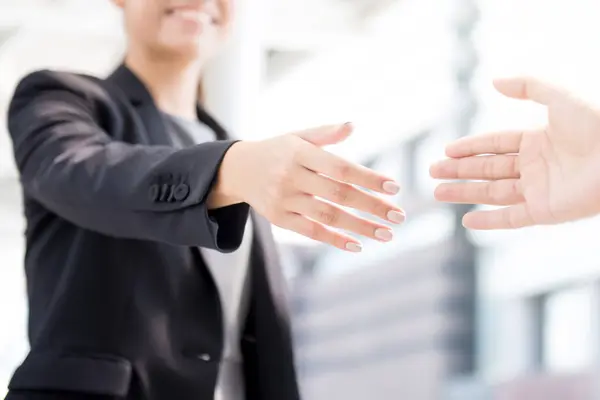 Businesswoman going to make handshake with a businessman — Stock Photo, Image