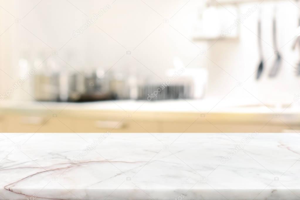 Marble stone table top (kitchen island) on blur kitchen interior