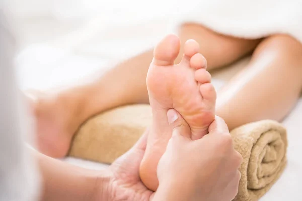 Therapist giving traditional thai foot massage to a woman in spa — Stock Photo, Image