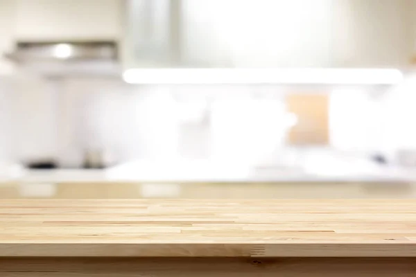 Wood countertop (or kitchen island) on blur kitchen interior bac