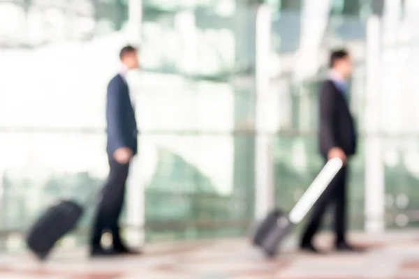 Blur businessmen with luggage at the airport — Stock Photo, Image