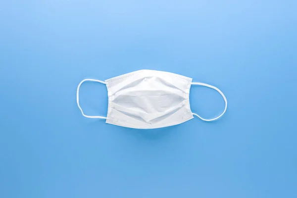 New Clean White Medical Face Mask Isolated Light Blue Paper — Stock Photo, Image