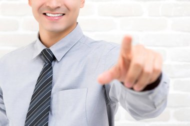 Gülümseyen işadamı eli boş sanal ekrana dokunuyor