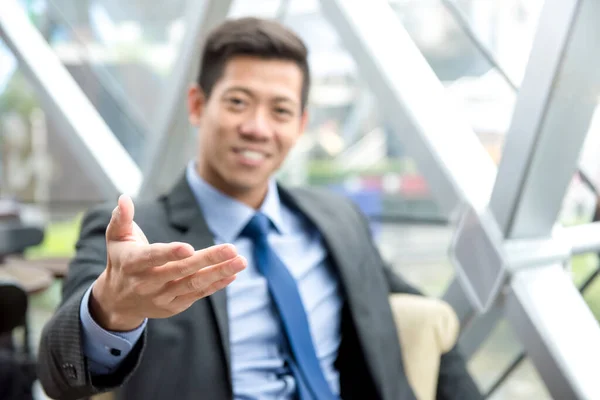 Friendly Asian Businessman Sitting Office Lounge Reaching Out Hand Open — Stock Photo, Image