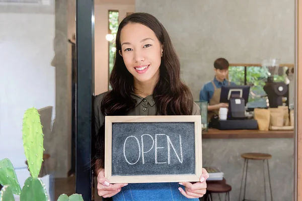 Young Asian Woman Entrepreneur Showing Open Sign Front Door Her — Zdjęcie stockowe