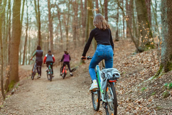 Family holiday. Bicycle walk in the forest with children