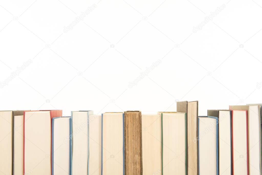 Row of books on a white background with space for copy