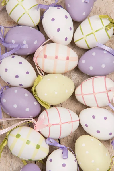 Pastel easter eggs with different colors on a wooden underground — Stock Photo, Image