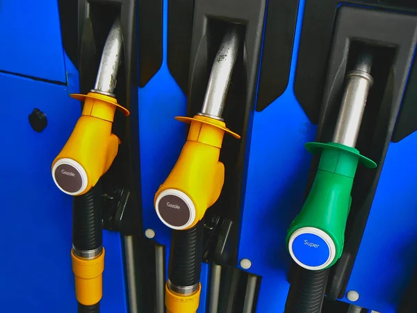 Three diesel and super unleaded 95 pumps, yellow and green, at a service station