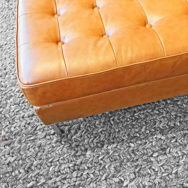 Leather seat on gray wool carpet — Stock Photo, Image