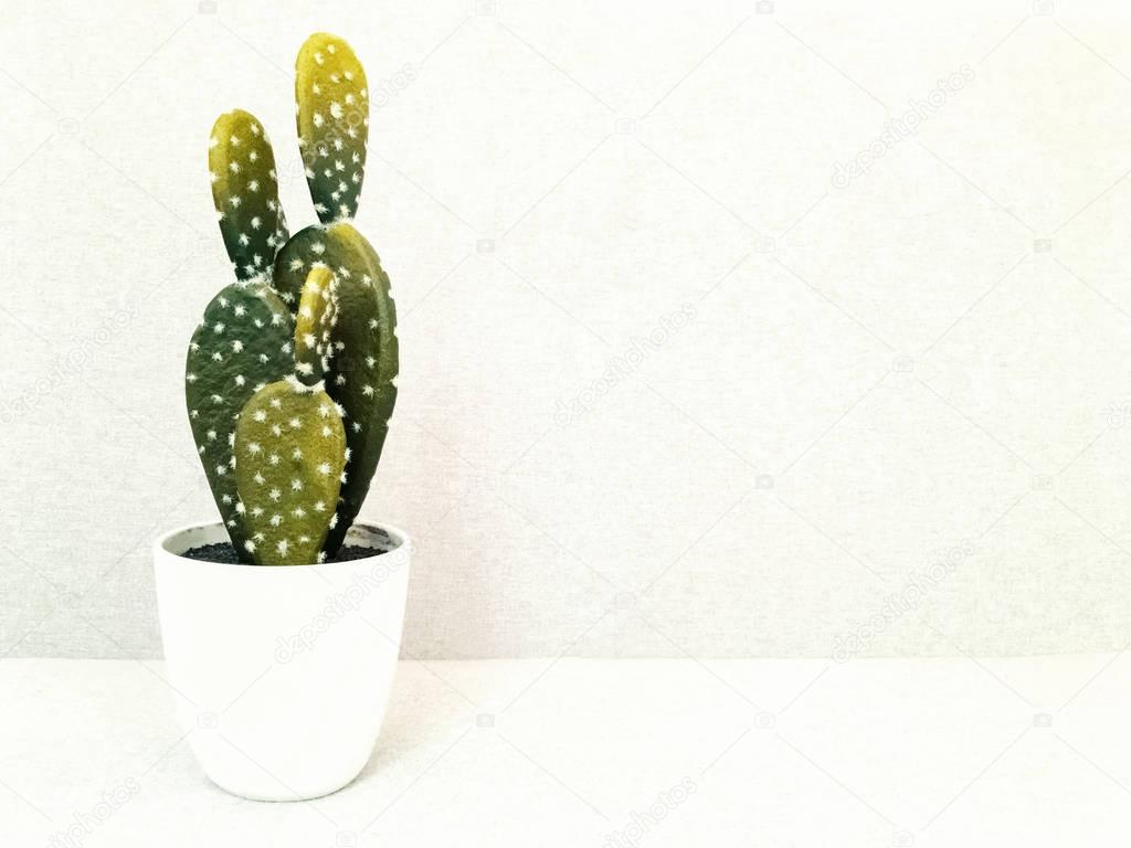 Artificial cactus in white ceramic pot