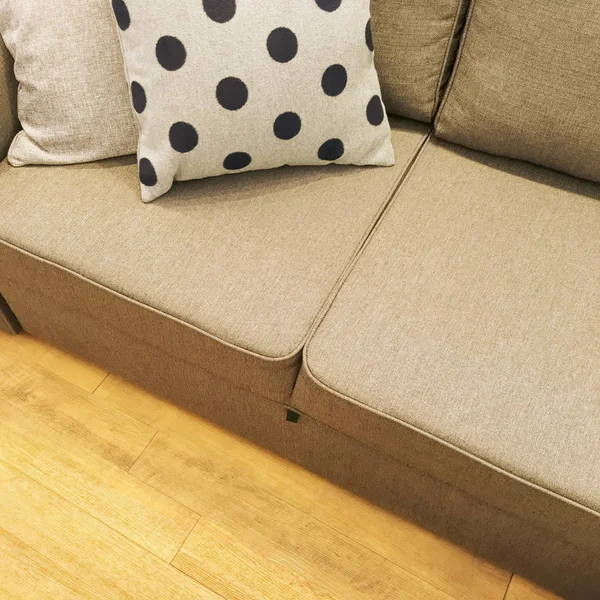 Polka dot cushion decorating a textile sofa — Stock Photo, Image