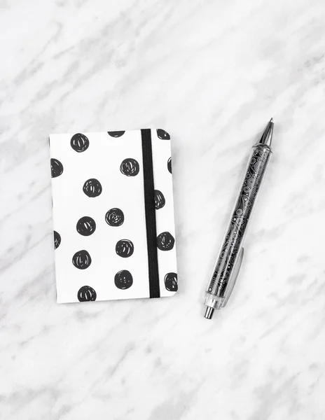 Black and white diary and pen on marble background — Stock Photo, Image