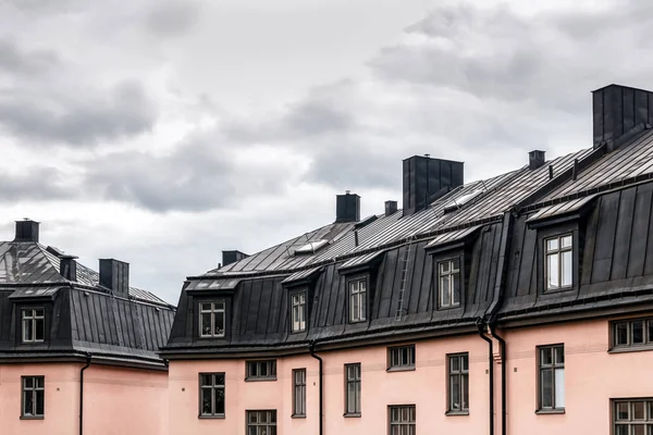 Pastel edifícios coloridos com telhados pretos — Fotografia de Stock
