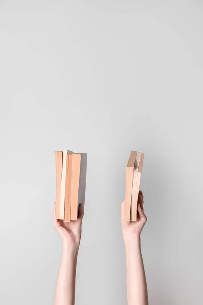 Female hands holding books — Stok fotoğraf