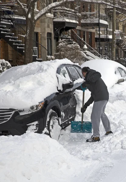 暴风雪过后 男人铲雪下了车 — 图库照片