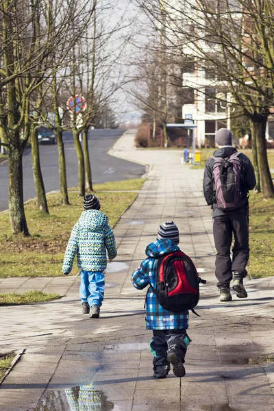Père et enfants marchant dans la rue — Photo