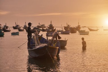 Muine, Vietnam - Mars 22, 2017: Fisher erkeklerde botlarının içinde Vietnam balıkçı köyü MUI ND'nin Vietnam
