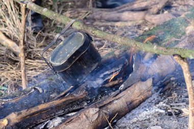 Kamp ateşi üzerinde kazan ile pişirme.