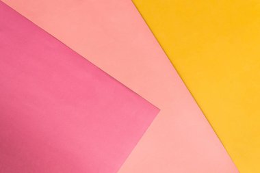 Abstract pink and yellow papers stacking together in abstract form. Abstract color paper background.