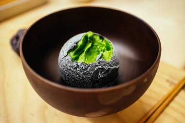 Japon çay evi tatlı kafesinde bir kepçe ev yapımı yeşil çay dondurması. Asya usulü lezzetli egzotik füzyon tatlısı..