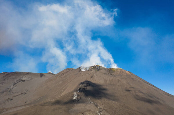 Aerial view photo from flying drone of on Mount Etna volcanic crater one of the flank craters is roughly circular depression in ground caused by volcanic activity and is typically bowl-shaped feature also showing people walking